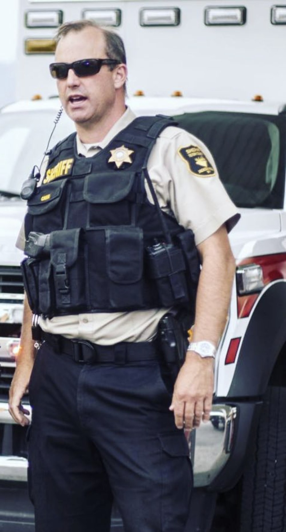 Sheriff Matt Carr on scene in front of emergency vehicles